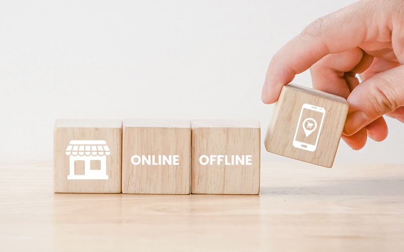 Hand placing mobile app block next to online and offline blocks